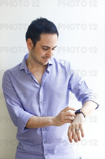 Caucasian man checking the time on wristwatch