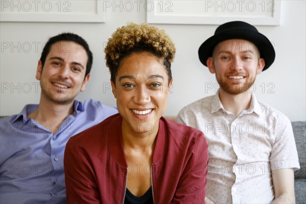 Portrait of smiling friends on sofa