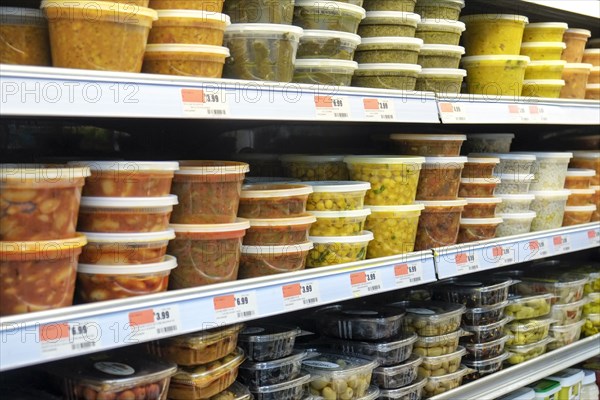 Plastic containers of food on supermarket shelves