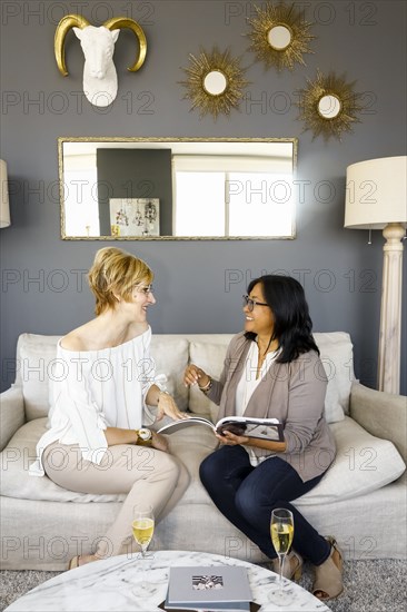 Women with champagne reading book