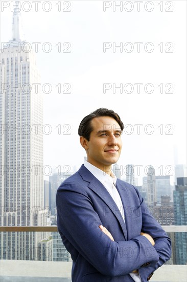 Confident Caucasian businessman on urban sidewalk