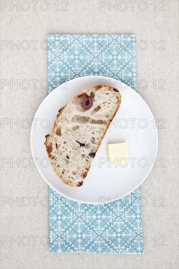 Olive bread and butter on plate