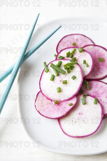 Sliced radishes on plate