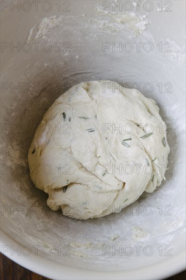 Rosemary bread dough in bowl