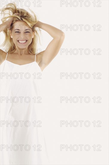 Studio shot of woman with hands in hair