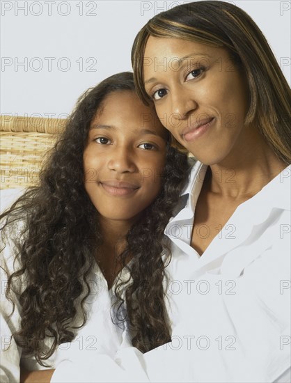 African American mother and daughter hugging