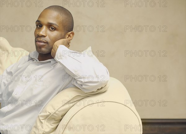 African American man sitting on sofa