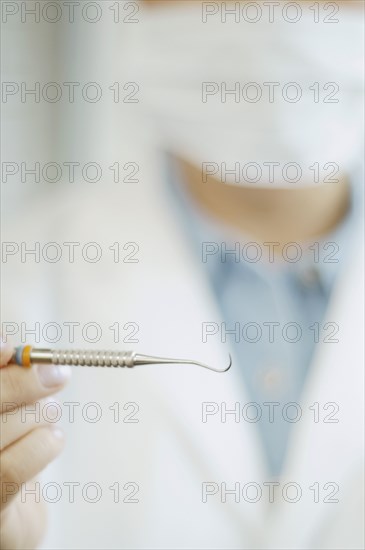 Close up of dental tool in dentist's hand