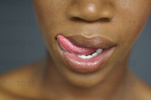 Close up of African woman licking lips