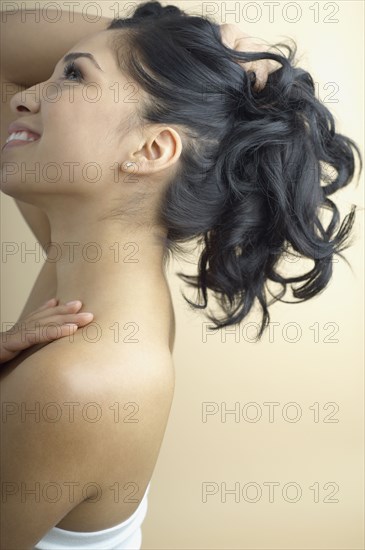 Hispanic woman holding up hair