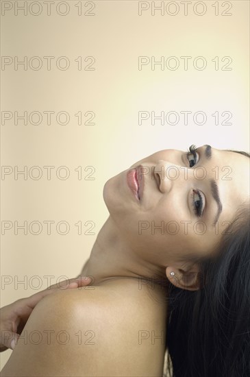 Hispanic woman leaning head back