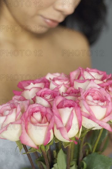 Hispanic woman holding bouquet of flowers