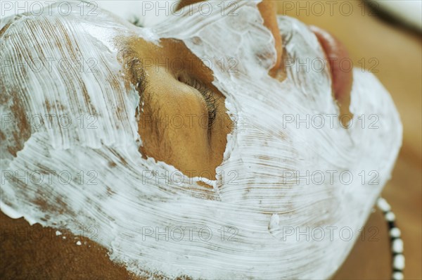 African man receiving spa facial treatment