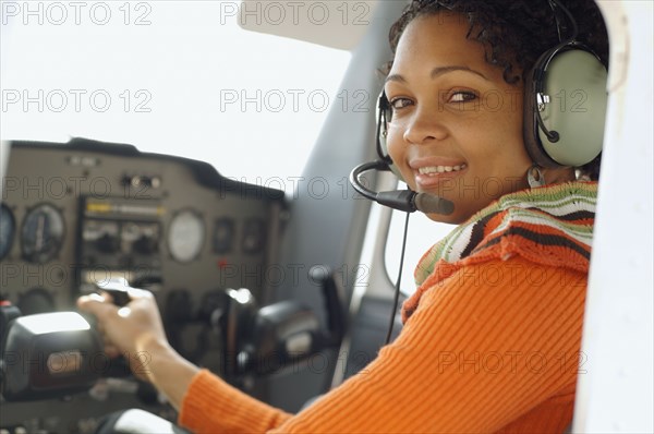 African woman in cockpit of airplane