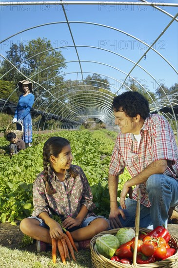 Multi-ethnic father and daughter with organic produce