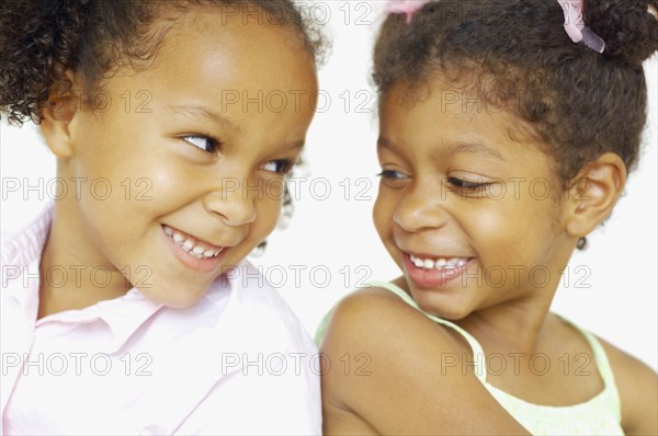 Close up of multi-ethnic girls smiling at each other