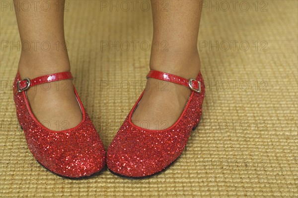 Close up of mixed race girl wearing red shoes