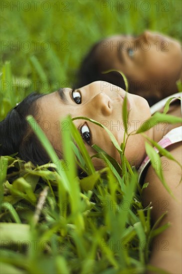 Indian girls laying in grass