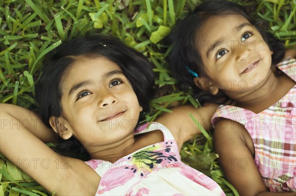 Indian girls laying in grass