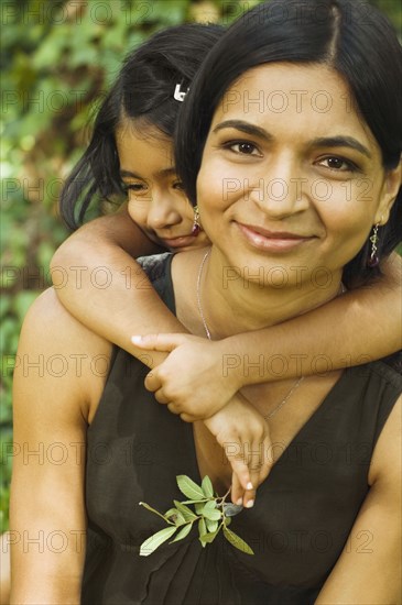 Indian daughter hugging mother