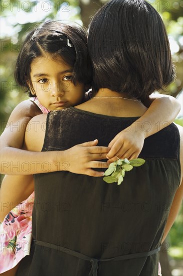 Indian daughter hugging mother