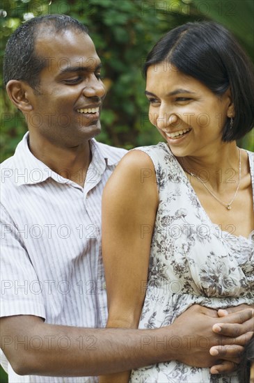 Indian couple hugging outdoors