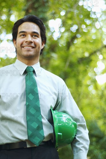 Hispanic businessman with green hard hat