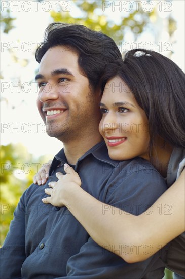 Hispanic couple hugging