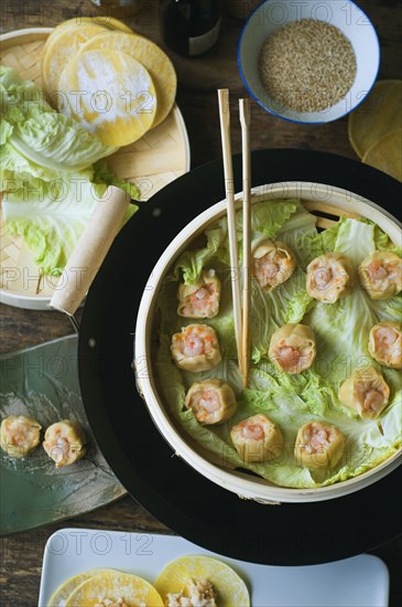 Asian dumpling in steamer with cabbage