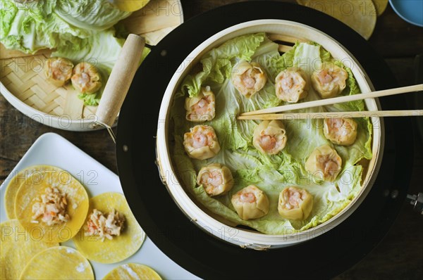 Asian dumpling in steamer with cabbage