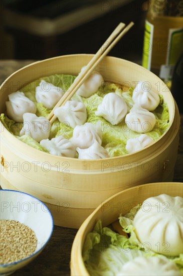 Asian dumpling in steamer with cabbage