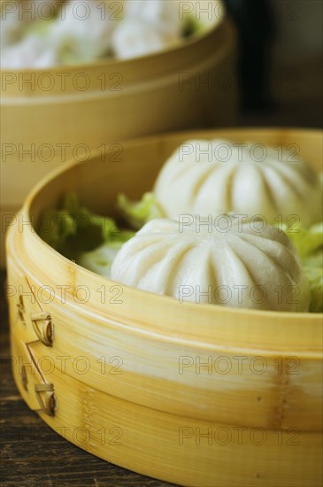 Asian dumpling in steamer with cabbage