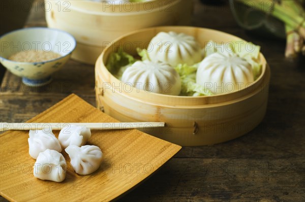 Asian dumpling in steamer with cabbage