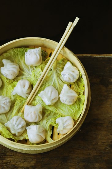 Asian dumpling in steamer with cabbage