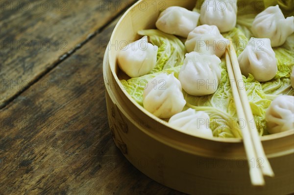 Asian dumpling in steamer with cabbage