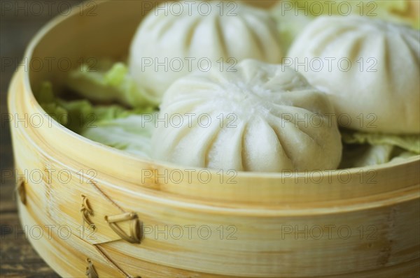 Asian dumpling in steamer with cabbage