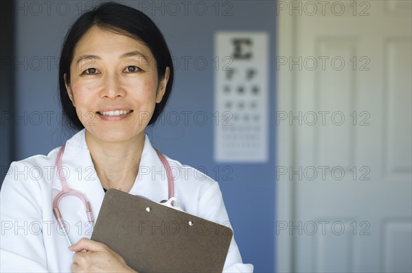 Japanese doctor standing in office