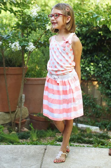 Hispanic girl smiling in backyard