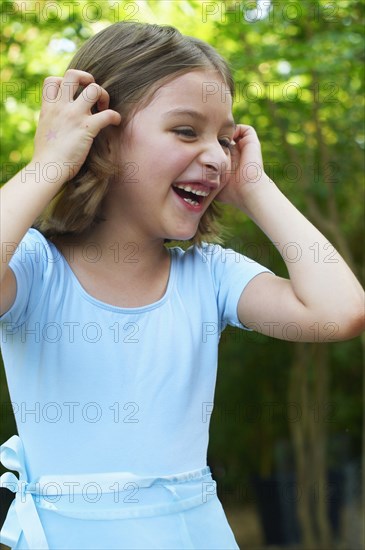 Hispanic girl laughing outdoors