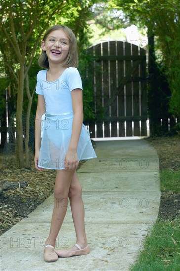 Hispanic ballerina laughing outdoors