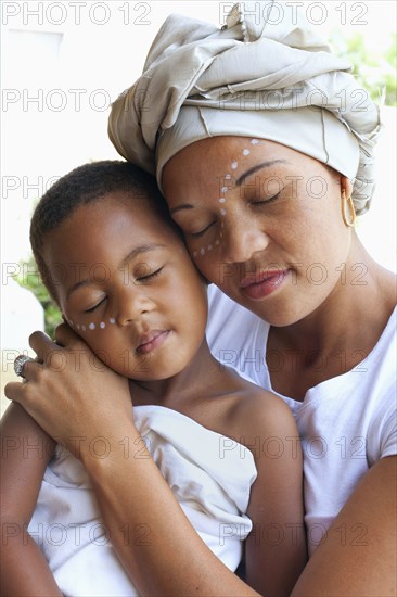 Mixed race mother and daughter hugging