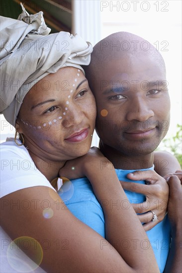 Mixed race couple hugging outdoors