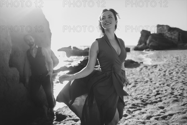 Caucasian couple walking on beach