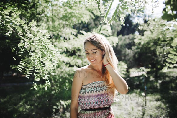 Caucasian woman standing near trees