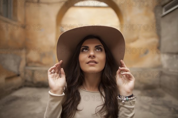 Caucasian woman wearing hat looking up