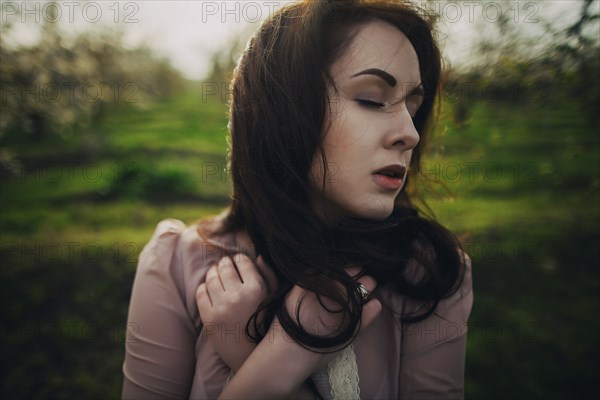 Wind blowing hair of Caucasian woman