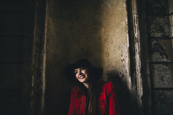 Portrait of smiling Caucasian woman leaning in alcove