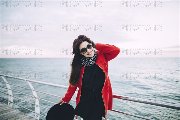 Portrait of smiling Caucasian woman standing on boardwalk