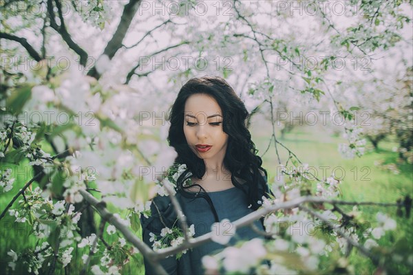 Caucasian woman standing near flowering tree