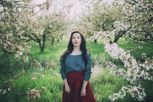 Caucasian woman standing near flowering trees